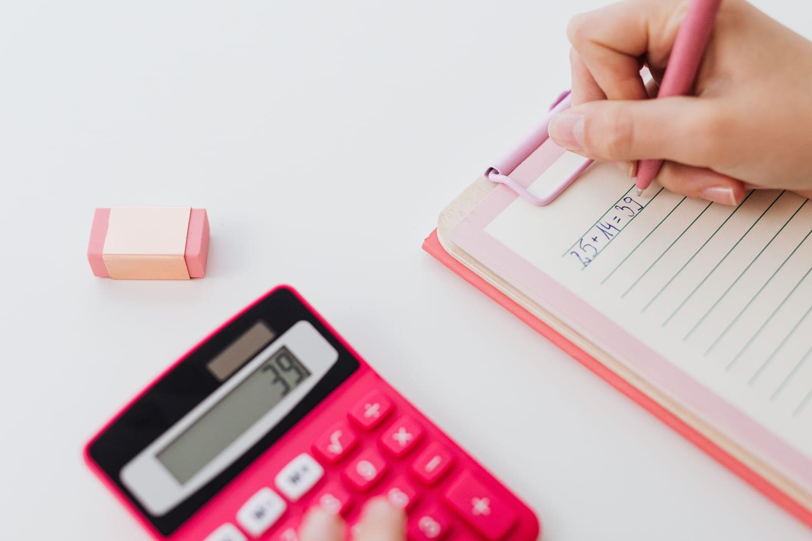 A notebook, calculator and tape measure beside an aquarium filter