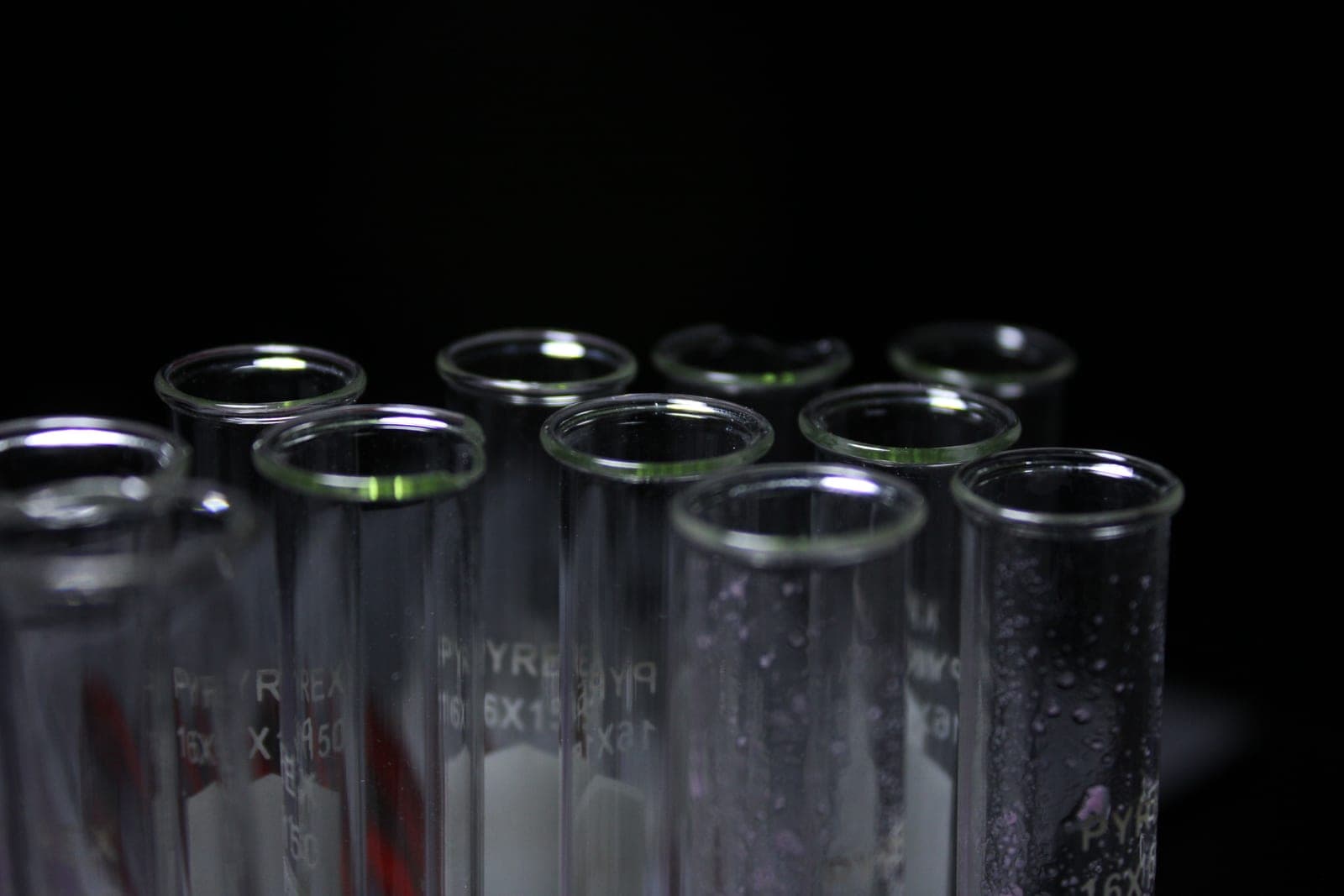 Glass test tubes of clear liquid held up to the light